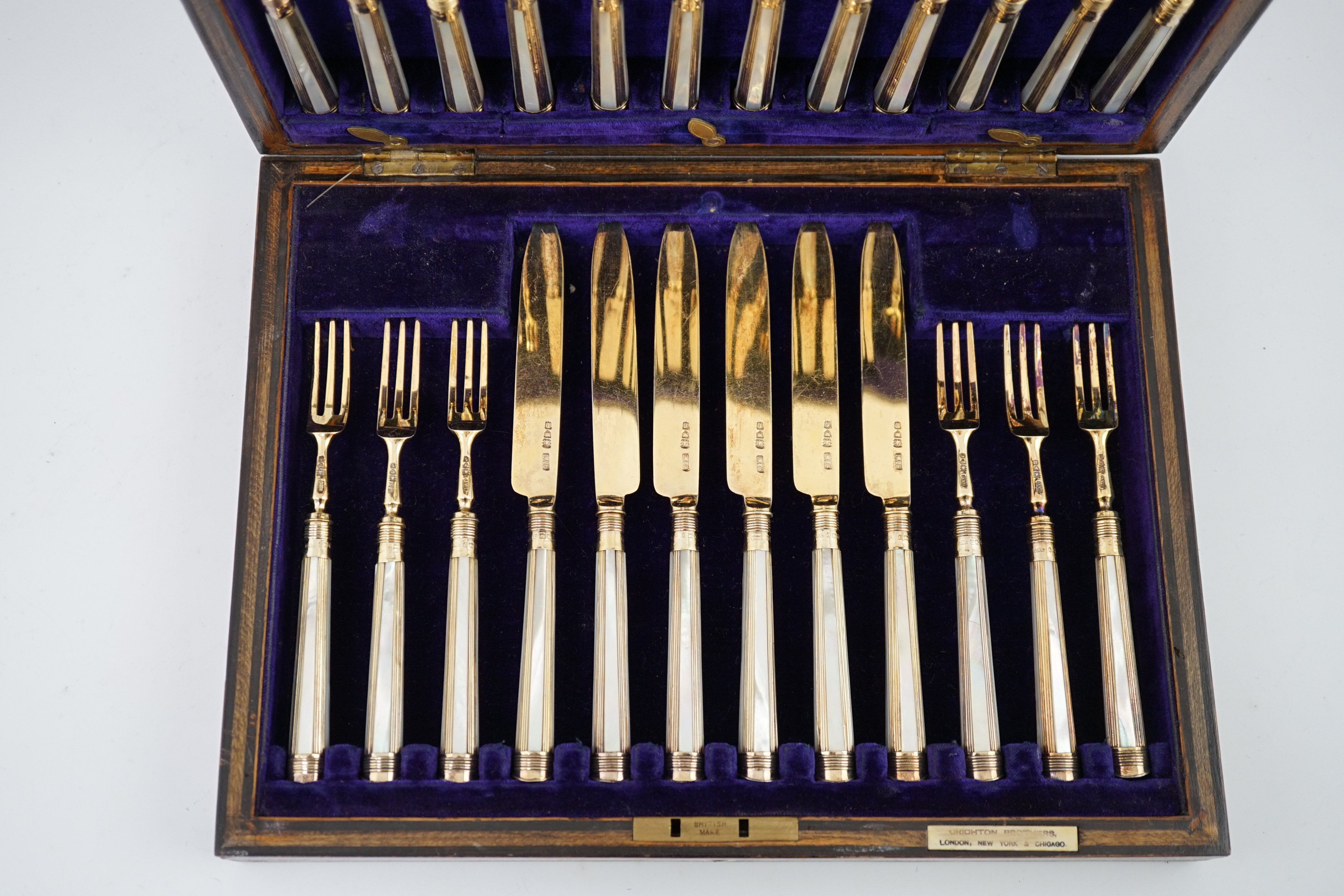 A cased set of twelve pairs of George V silver gilt dessert eaters by Crichton Brothers